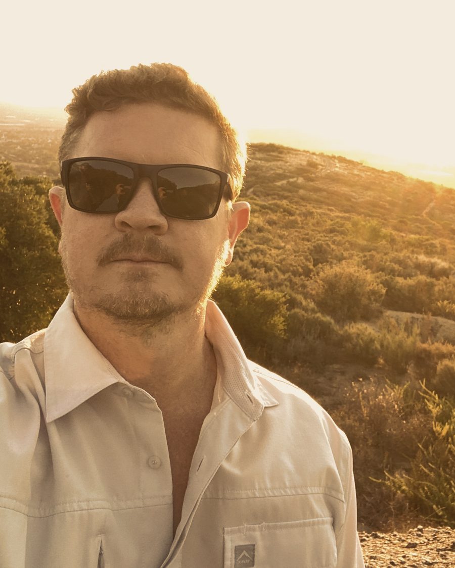 Lukas on a hillside at sunset